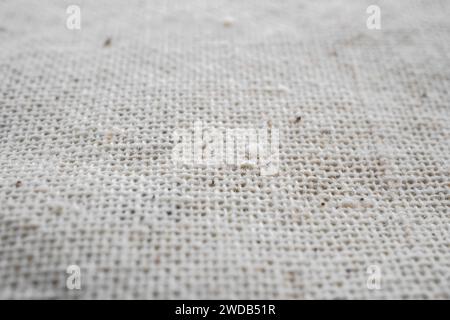 Macro detail of woven white linen natural fabric texture background, selective focus Stock Photo