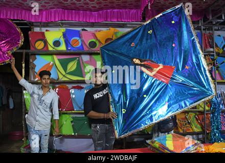Sharp String Kite Shopkeeper poses for a photo with a huge kite on the eve of Makar ...