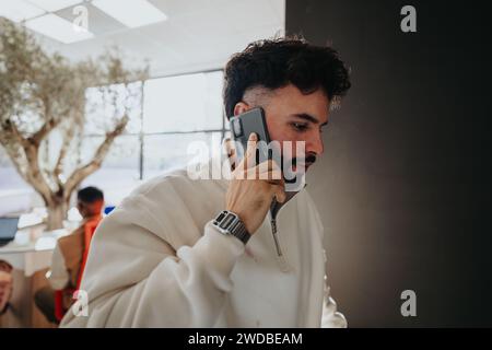 Business person having phone call while walking in the hall. Stock Photo