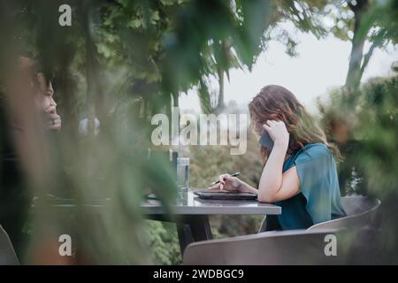 Young partners discussing innovative market expansion in an urban setting. Analyzing research for targeting audience and driving profits. Stock Photo