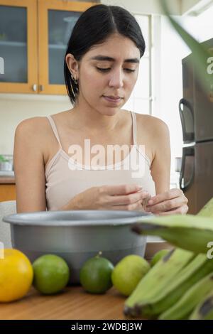 young woman doing housework, getting ingredients ready for cooking, kitchen interior with chef work details, lifestyle and food Stock Photo