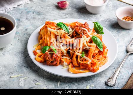 Pasta with mini meatballs, tomato sauce and parmesan cheese Stock Photo