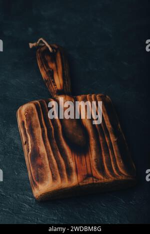 Small Handmade Cutting Board on Dark Concrete Background Stock Photo