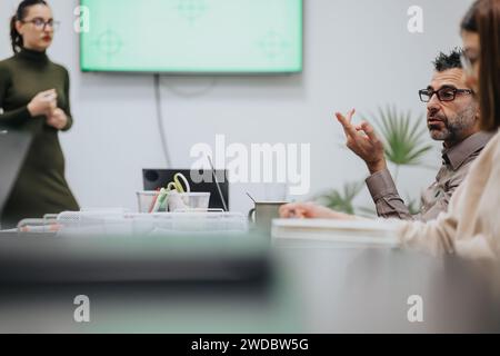 Business team collaborating in late evening meeting. Stock Photo