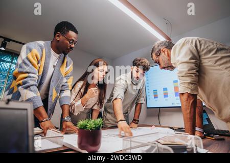 Multiracial Architects Collaborating in a Creative Boardroom Meeting for Project Development and Financial Planning Stock Photo