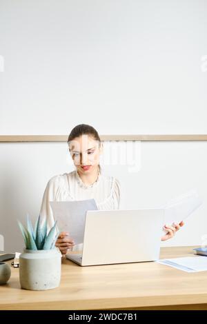 Woman working with papers in modern office Stock Photo