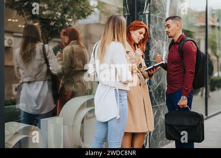 Diverse professionals collaborate on data analysis, discussing marketing strategies and successful business outcomes in a vibrant urban city. Stock Photo