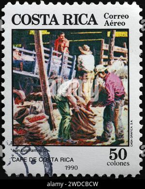 Painting of Costa Rican farmers at work in a coffee plantation on stamp Stock Photo