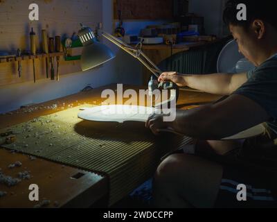 Stringed instrument maker master luthier hand proceed with graduation work in progress violon cello back plate, using, thickness gauge caliper Stock Photo