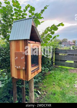 Wooden book box in garden. Free library Stock Photo