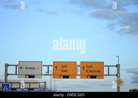 Trogir, Croatia - September 24, 2023: Road signs and traffic signals against blue sky Stock Photo