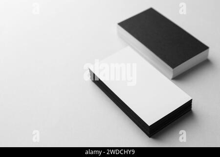 Blank black and white business cards on light background. Mockup for design Stock Photo
