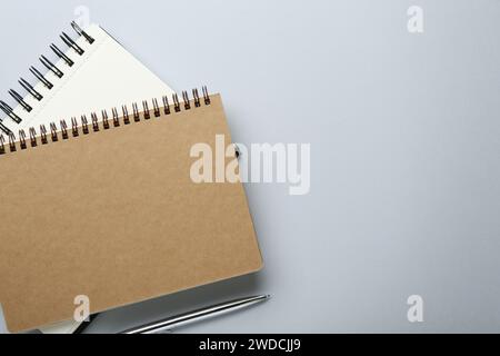 Notebooks on light grey background, top view. Space for text Stock Photo