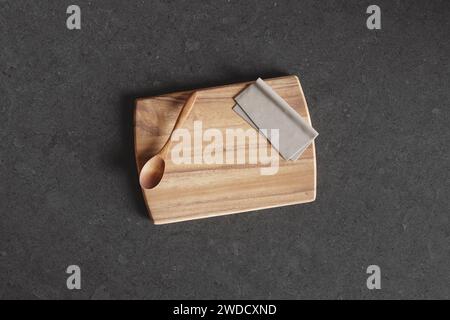 Cutting board on a wooden table. Culinary background. Empty wooden cutting board, product display space. Stock Photo