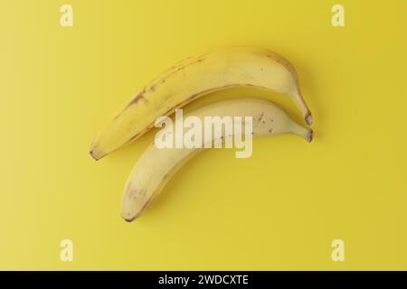 Photograph of Fresh banana on solid yellow background Stock Photo