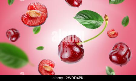 red cherry with water drops flying in the air stream on pink background Stock Photo