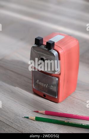 a red pencil sharpener with timber background Stock Photo