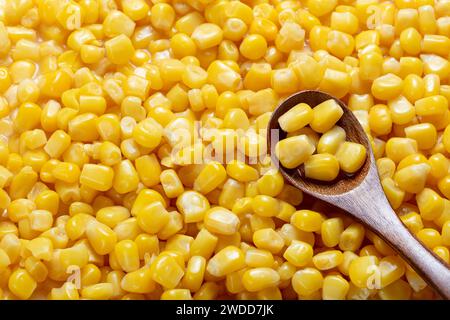 sweetcorn in wooden spoon on corn background Stock Photo