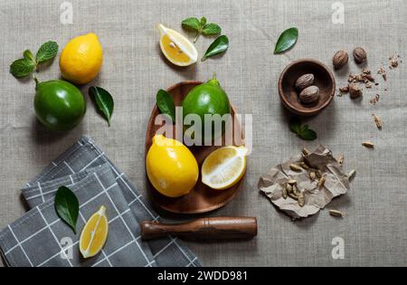 lemons with limes and slices on canvas background Stock Photo