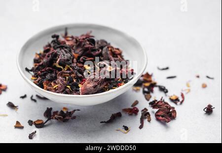 Bowl with Dry Hibiscus Tea on a table Stock Photo