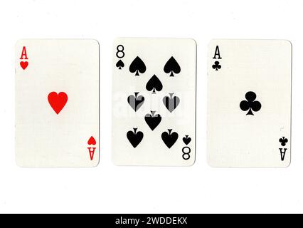 Vintage playing cards showing a pair of aces and a black eight isolated on a white background. Stock Photo