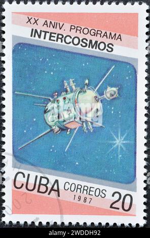 Cancelled postage stamp printed by Cuba, that shows 'Cosmos 93' satellite, Cosmonautics Day. 20th Anniversary of Intercosmos Program, circa 1987. Stock Photo