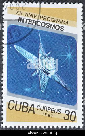 Cancelled postage stamp printed by Cuba, that shows Molniya communications satellite, Cosmonautics Day. 20th Anniversary of Intercosmos Program, circa Stock Photo