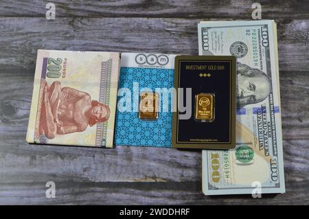 Cairo, Egypt, January 18 2024: Egyptian money pounds, American dollars banknotes bills, BTC Bullion Trading Center and SAM precious metal 24K karat pu Stock Photo