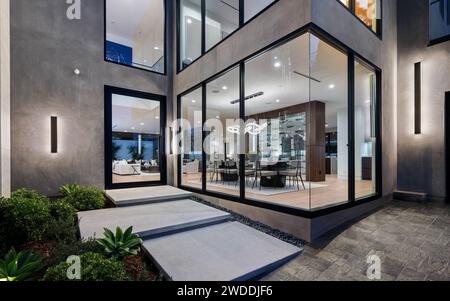 A spacious glass building with contemporary design, featuring side stairs for convenient access, New Construction Home in Tarzana, California Stock Photo