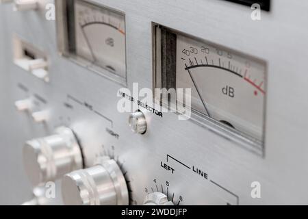 Old vintage stereo amplifier, aluminium front panel with knobs, buttons, dials and switches, close-up shot Stock Photo