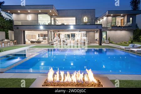 A Fire pit near a pool on the ground, New Construction Home in Tarzana, California Stock Photo