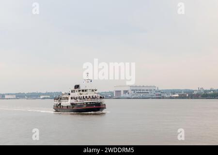 Ferry across the Mersey. A passenger ferry, crossing the river Mersey, in Liverpool, England, on an overcast day. Stock Photo