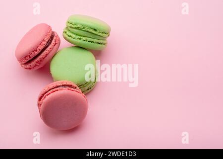 Colorful french macarons isolated on pink background. Stock Photo
