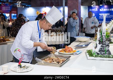 Harbin, China's Heilongjiang Province. 20th Jan, 2024. A chef cooks during a food festival in Harbin, northeast China's Heilongjiang Province, Jan. 20, 2024. Credit: Xie Jianfei/Xinhua/Alamy Live News Stock Photo
