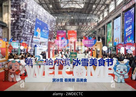 Harbin, China's Heilongjiang Province. 20th Jan, 2024. Tourists taste food during a food festival in Harbin, northeast China's Heilongjiang Province, Jan. 20, 2024. Credit: Xie Jianfei/Xinhua/Alamy Live News Stock Photo
