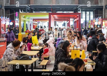 Harbin, China's Heilongjiang Province. 20th Jan, 2024. Tourists taste food during a food festival in Harbin, northeast China's Heilongjiang Province, Jan. 20, 2024. Credit: Xie Jianfei/Xinhua/Alamy Live News Stock Photo