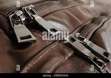 Zippers on an old leather backpack, close-up, brown Stock Photo