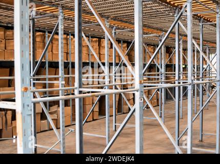 industrial heavy-duty metallic shelves and carton boxes storage solutions in a warehouse Stock Photo