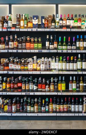 Bottles with various alcoholic beverages on display in a store. Ukraine, Vinnytsia, 2024.01.13 Stock Photo