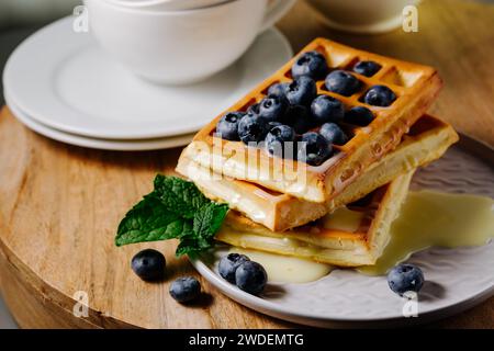 Viennese waffles with condensed milk and blueberries. Stock Photo