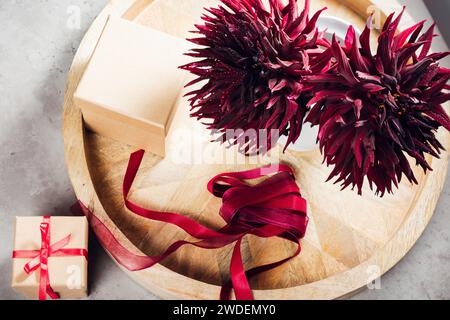 Two black dahlia flowers, gift boxes with red ribbon. Stock Photo