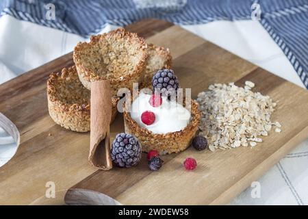 Homemade recipe made with oat flakes and natural yogurt filling, berries. Delicious and healthy breakfast snack preparation Stock Photo