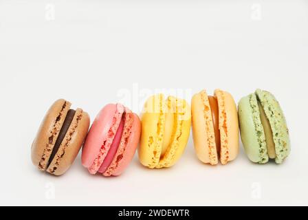 Selection of macarons in a line on a white background Stock Photo