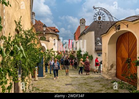 Dürnstein, Lower Austria – AT – June 8, 2023 Landscape image of tourists walking down one of Dürnstein’s picturesque stone streets celebrating Corpus Stock Photo