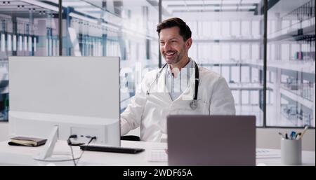 Happy Excited Male Doctor Raising Arms In Hospital Stock Photo