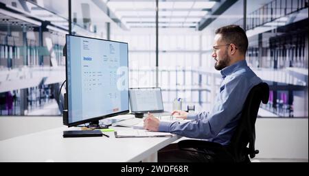Businessperson Analyzing Invoice On Computer In Office Stock Photo