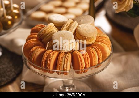 Pastel colored macarons in elegant glass bowl on sweet table Stock Photo