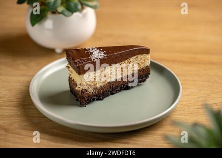 Slice of triple chocolate mousse cake on plate Stock Photo