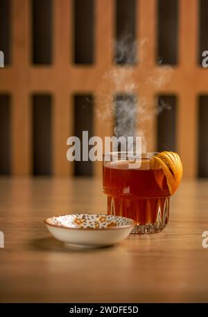 Glass cup of hot tea decorated with orange peel Stock Photo