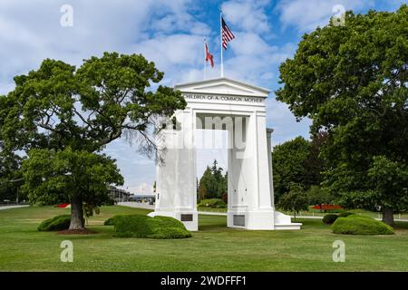 The gate monument in Peace Arch Park, Blaine, Washington, USA. Two countries flags on the monument in Peace Arch Park. USA Canada border. Historical l Stock Photo